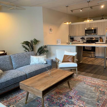 Open-plan living and kitchen with pendant lights