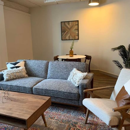 Modern furnished living room with grey sofa and wood coffee table